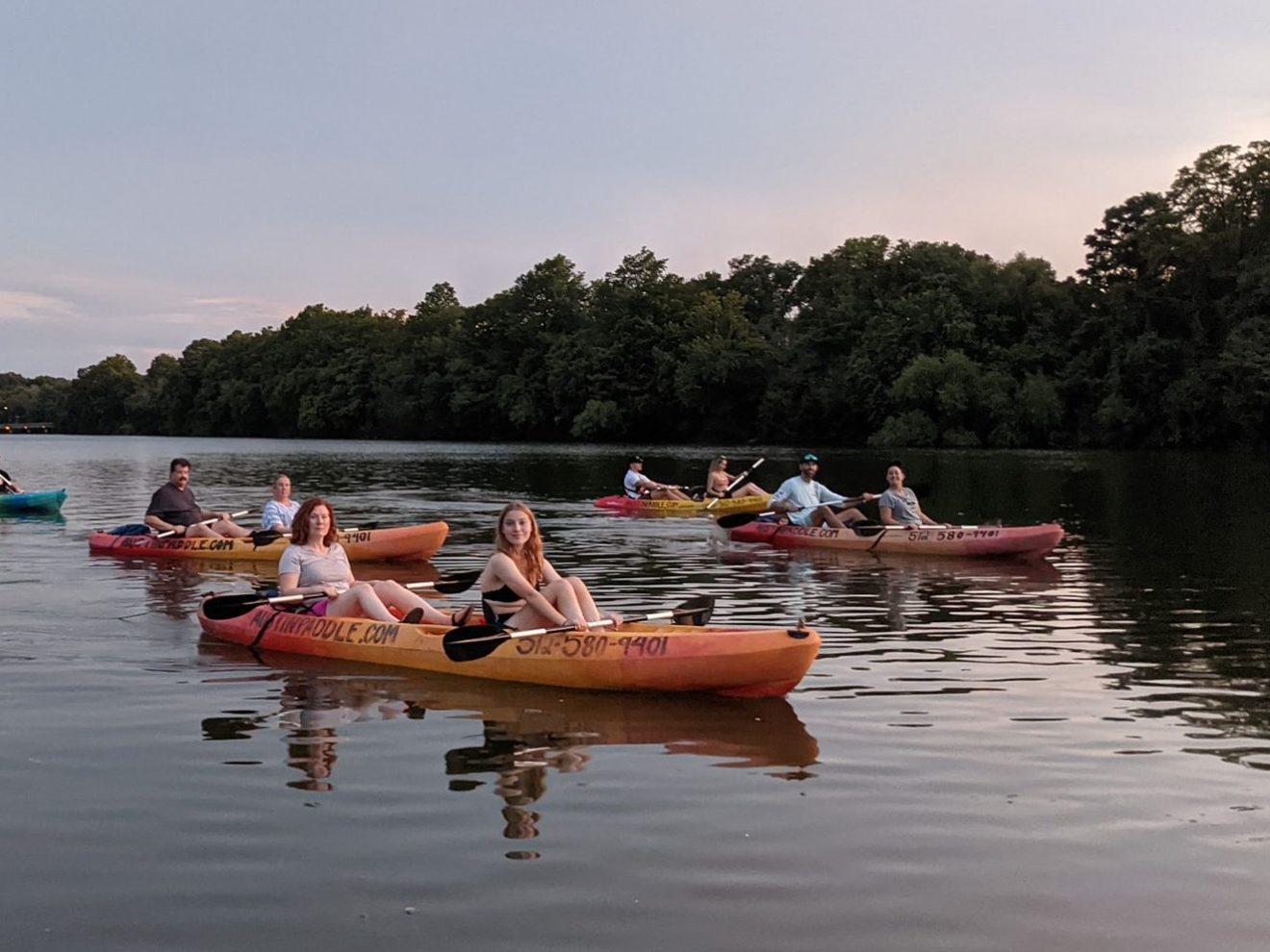 a group of people in a small boat in a body of water