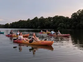 a group of people in a small boat in a body of water