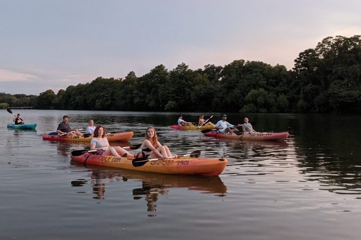 a group of people in a small boat in a body of water