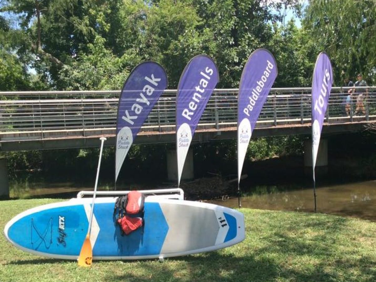 a group of lawn chairs sitting on top of a grass covered field