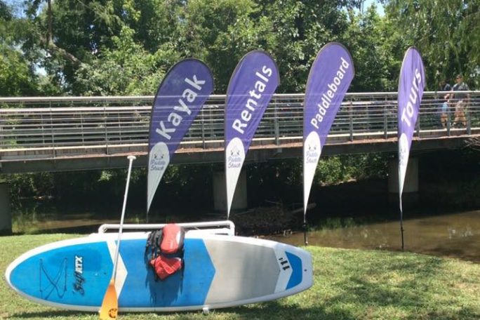 a group of lawn chairs sitting on top of a grass covered field