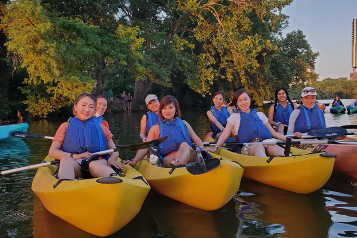 a group of people sitting on a boat in the water