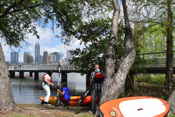 a person sitting on a bench in a park