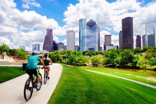 a person riding a bicycle in front of a building