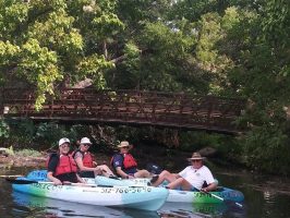 a group of people on a boat in the water