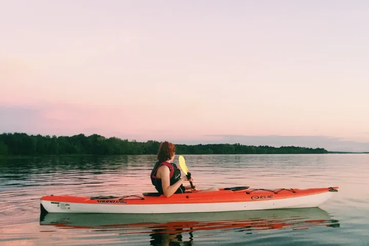 a person riding a surf board on a body of water