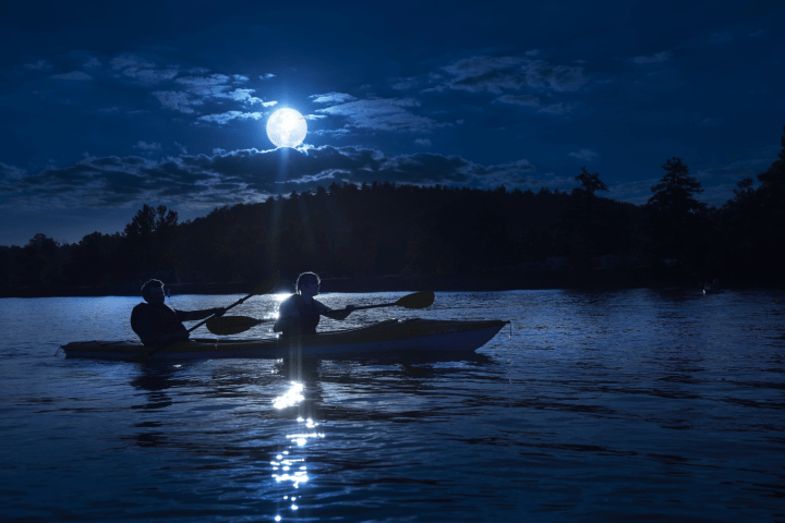 a man riding on the back of a boat in the water