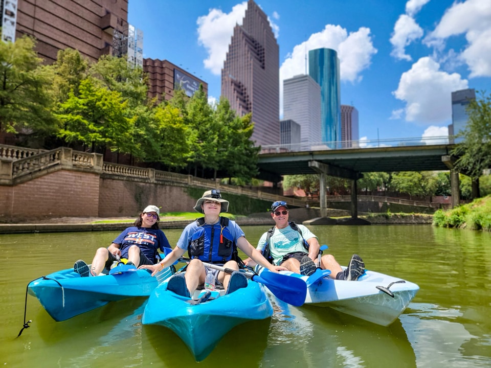 houston kayak tour a group of people riding on the back of a boat