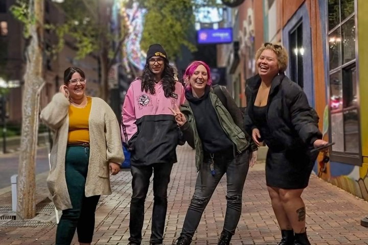 a group of people standing on a sidewalk