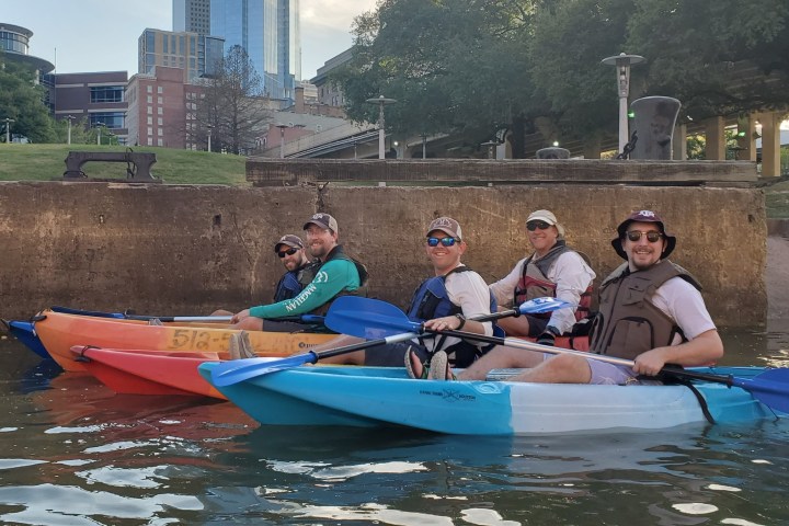 a group of people riding on the back of a boat